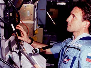 NASA/Mir-23 researcher Jerry Linenger works with the Mir Interface to Payloads System (MIPS) in the Priroda module.